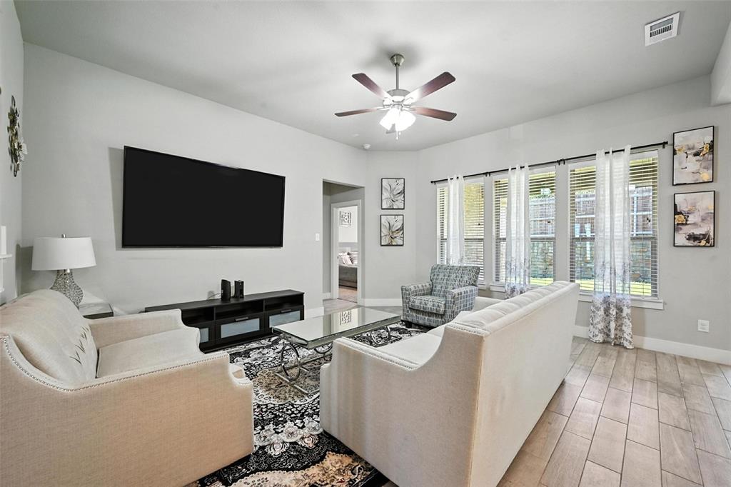 113 Nathan Drive Princeton, TX 75407 - Photo 3 of 39 a living room with furniture and a flat screen tv