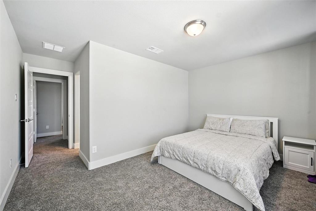 113 Nathan Drive Princeton, TX 75407 - Photo 31 of 39 a bedroom with a bed and a mirror