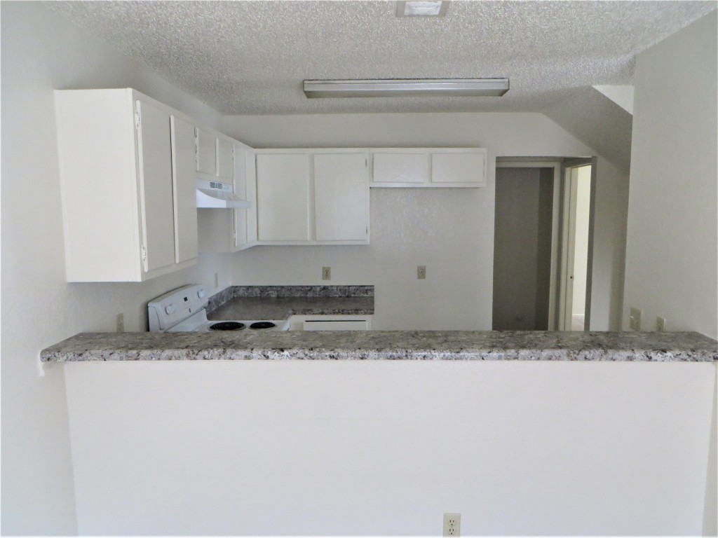 2217 Katy Lane, Unit C Georgetown, TX 78626 - Photo 19 of 21 a white kitchen with sink and granite