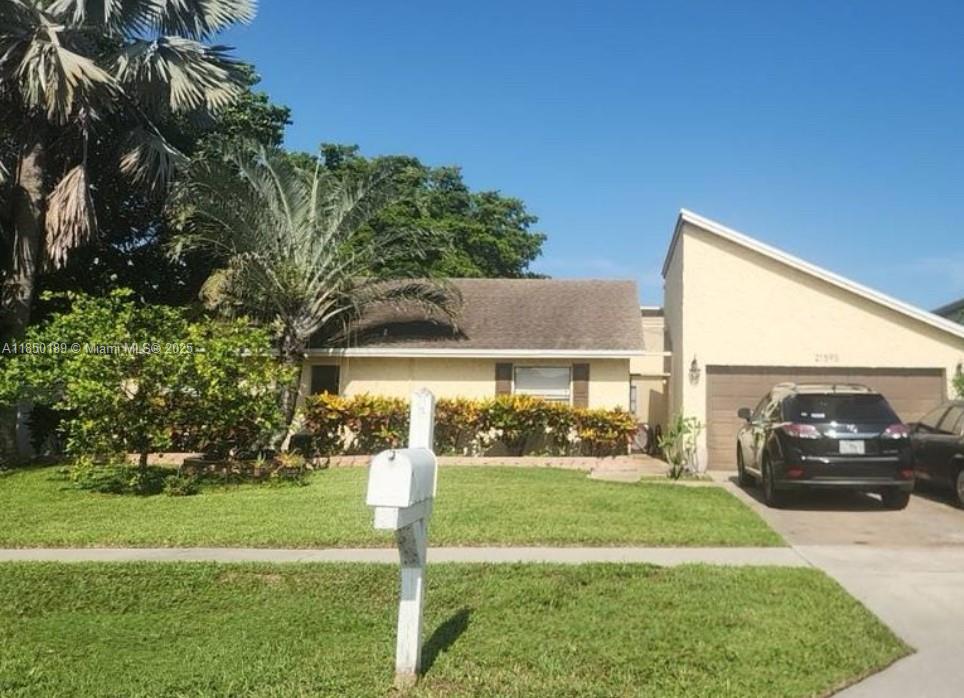 21595 Redbay Road Boca Raton, FL 33433 - Photo 1 of 2 a front view of a house with a yard