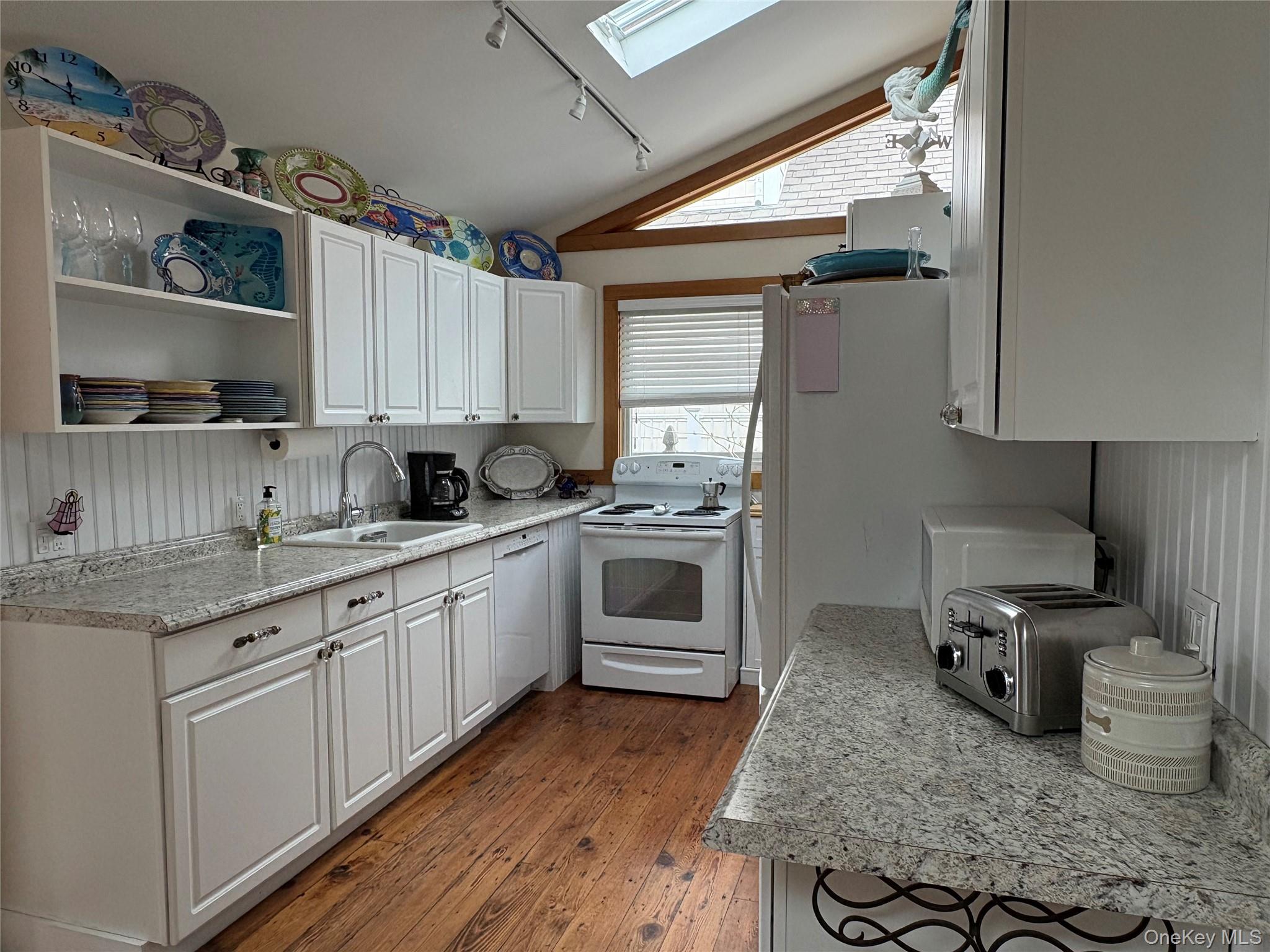 177 Wilmot Road Ocean Beach, NY 11770 - Photo 2 of 12 a kitchen with granite countertop a sink stainless steel appliances and cabinets