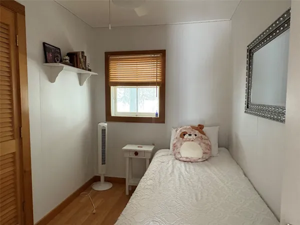 a bedroom with a bed and window