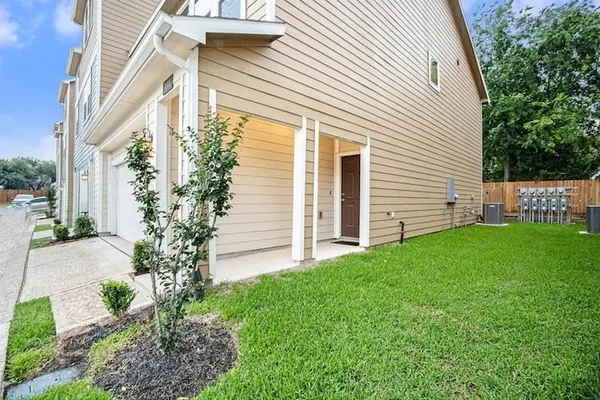 a view of a house with a yard and garden