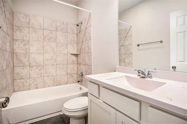 a bathroom with a sink a toilet and a bathtub