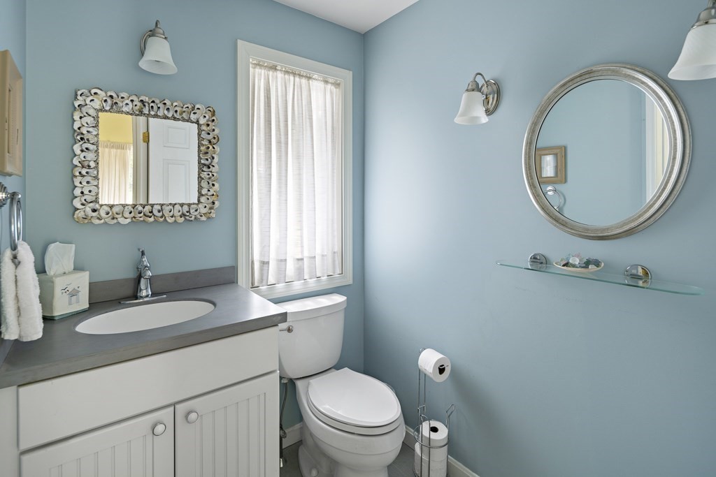 64 Jernegan Pond Road Edgartown, MA 02539 - Photo 14 of 25 a bathroom with a toilet a sink and mirror