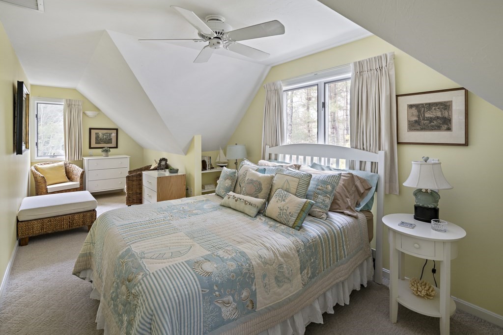 64 Jernegan Pond Road Edgartown, MA 02539 - Photo 15 of 25 a bedroom with a bed and a table