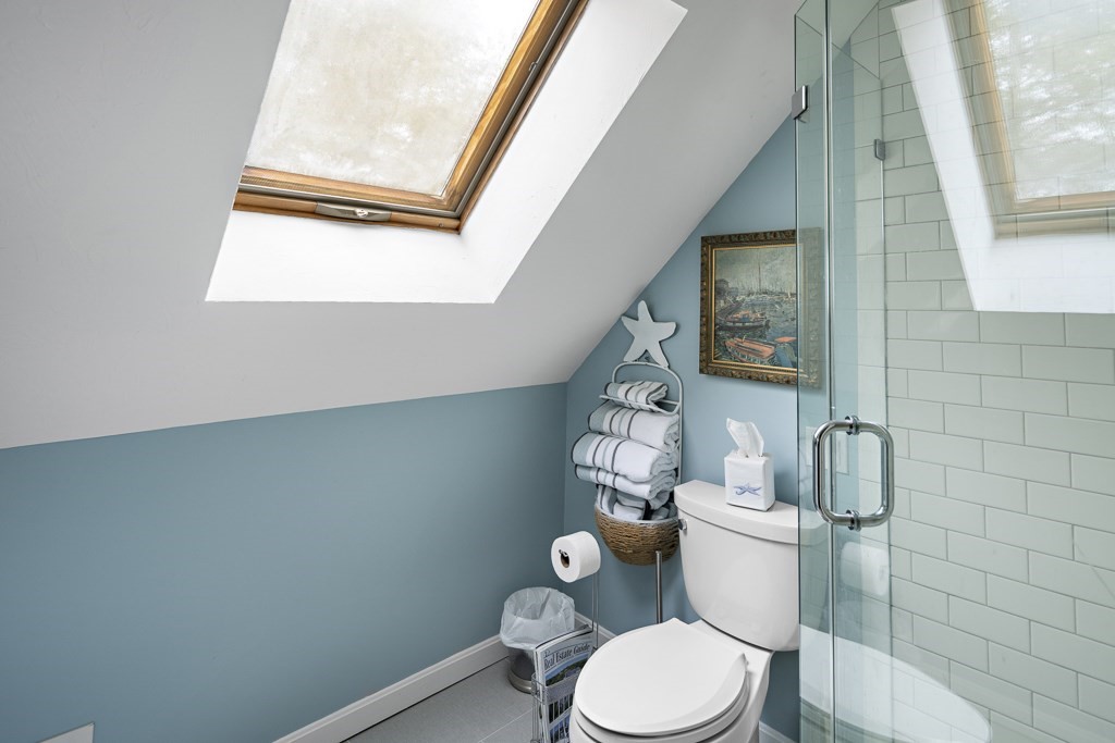 64 Jernegan Pond Road Edgartown, MA 02539 - Photo 19 of 25 a white toilet sitting next to a bathroom sink and a mirror