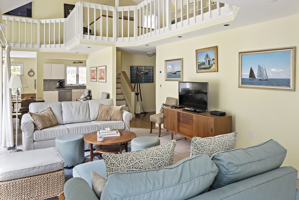64 Jernegan Pond Road Edgartown, MA 02539 - Photo 2 of 25 a living room with furniture and a flat screen tv