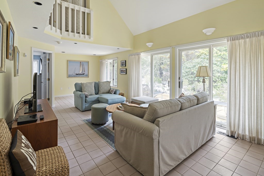 64 Jernegan Pond Road Edgartown, MA 02539 - Photo 4 of 25 a living room with furniture and a floor to ceiling window