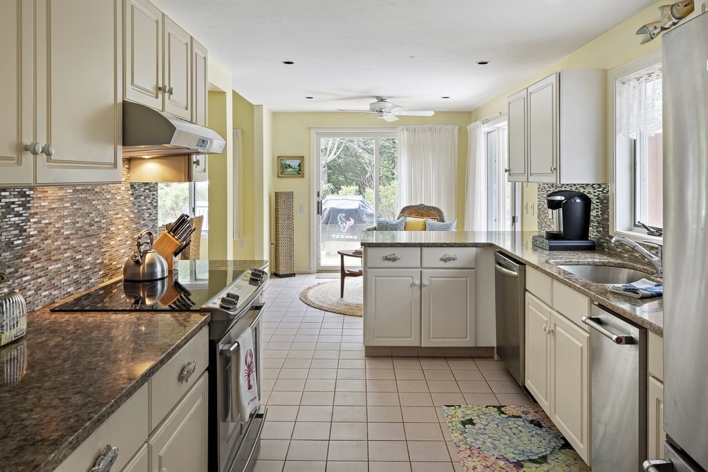 64 Jernegan Pond Road Edgartown, MA 02539 - Photo 10 of 25 a kitchen with a sink stove and cabinets