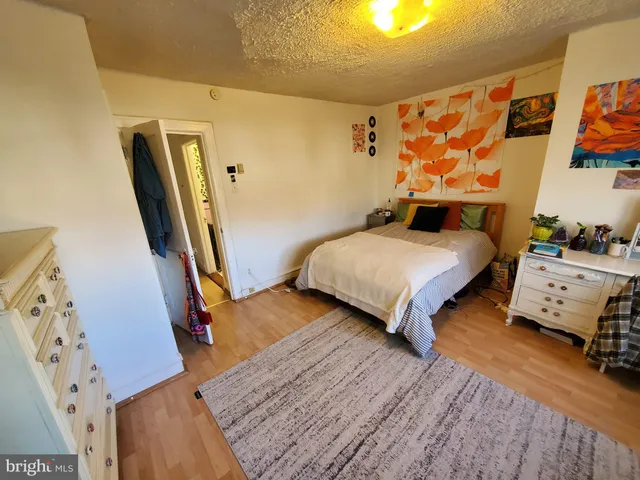 a bedroom with 2 bed and wooden floor
