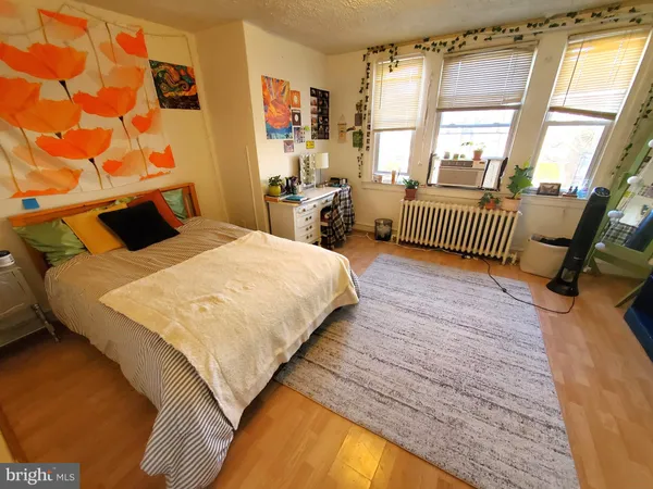 a bedroom with a bed next to a large window with the outer view