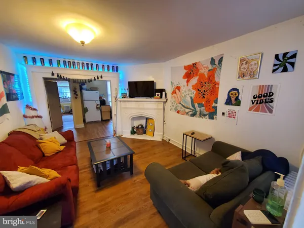 a living room with furniture a flat screen tv and a fireplace
