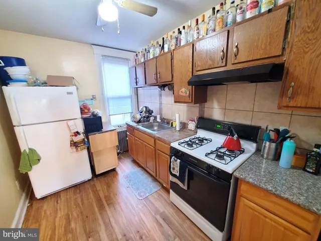 a kitchen with stainless steel appliances granite countertop a stove a sink dishwasher and a refrigerator