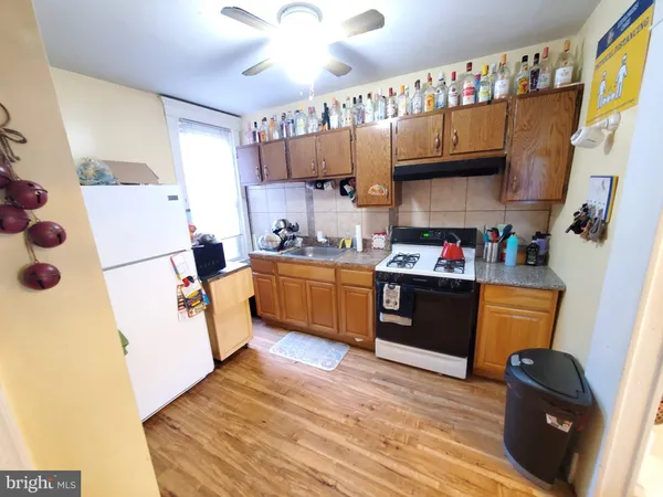 a kitchen with a sink cabinets and a refrigerator