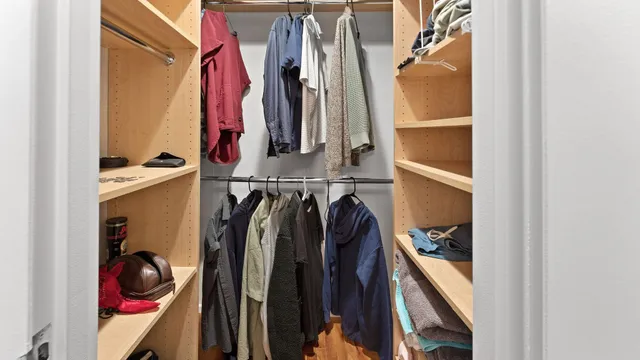 a view of walk in closet with clothes and shoes