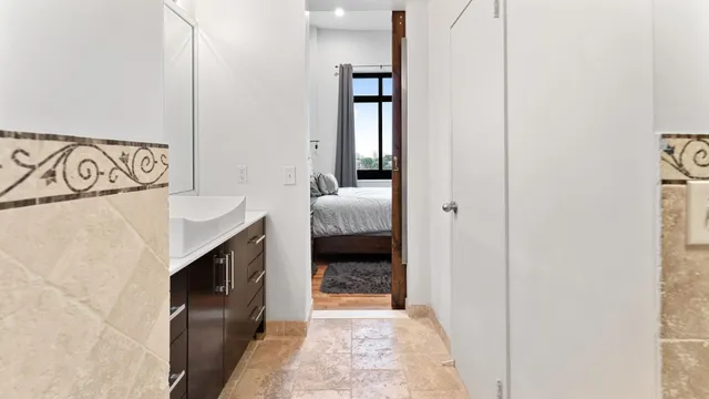 a en suite bathroom with a sink and a mirror