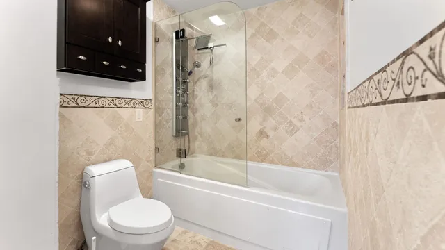 a bathroom with a toilet a sink and bathtub