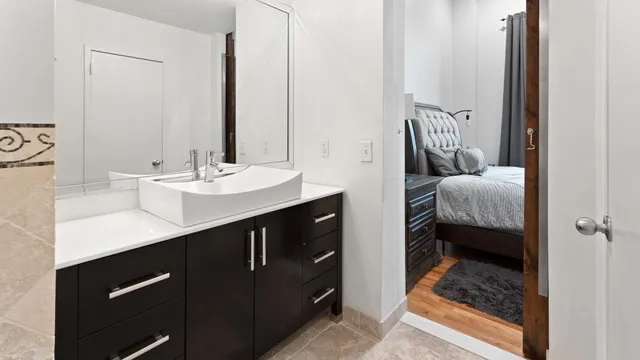 a en suite bathroom with a sink and a mirror