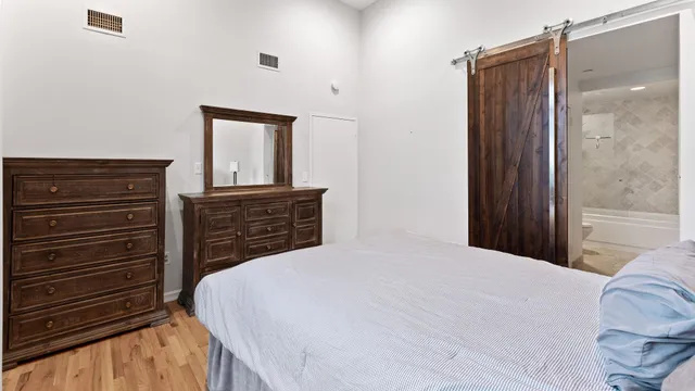 a bedroom with a bed and a dresser