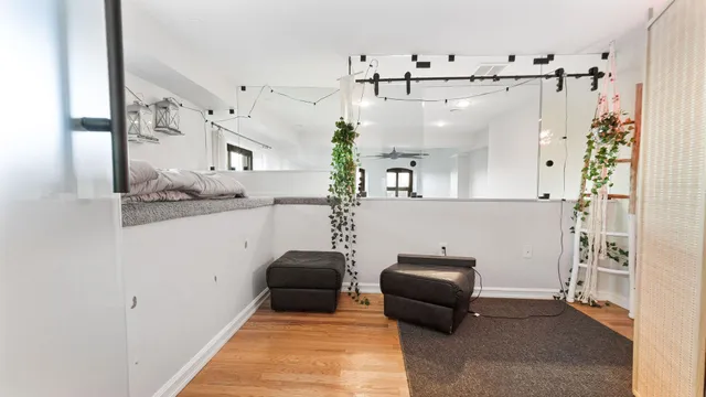 a hallway with a couch and a potted plant