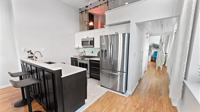 a kitchen with cabinets and stainless steel appliances