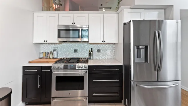 a kitchen with stainless steel appliances granite countertop a refrigerator stove and microwave