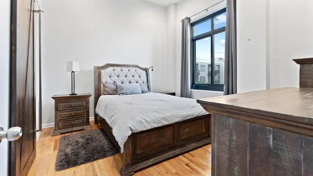 a bed sitting in a bedroom next to a window