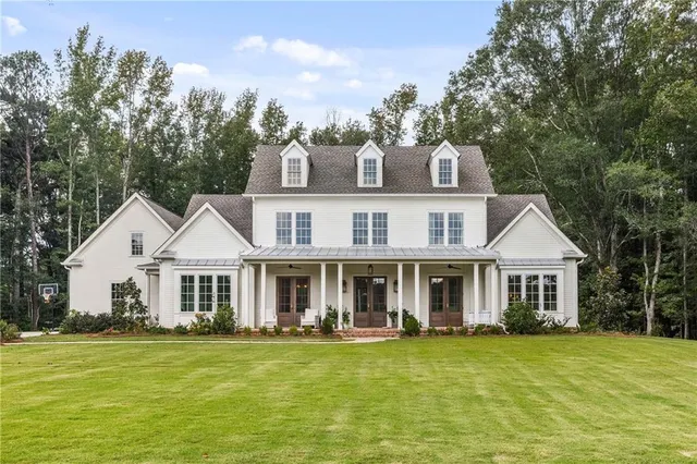 a front view of a house with a garden