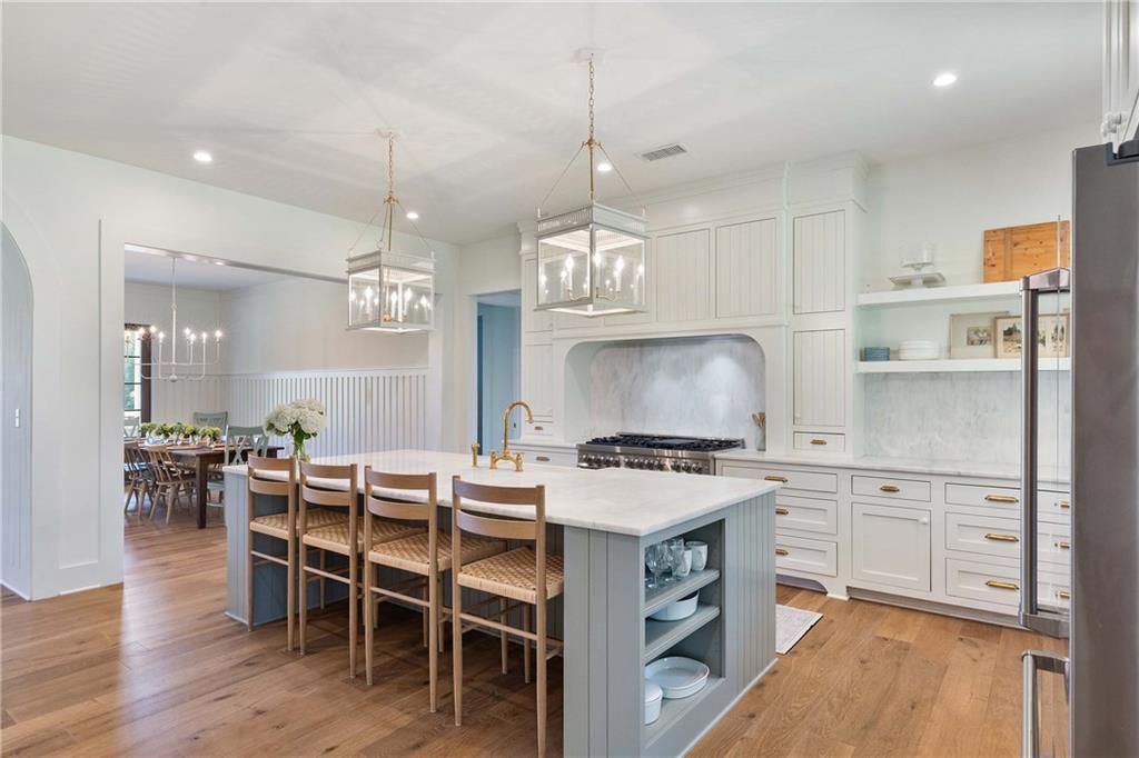 9311 Waterworks Road Chattahoochee Hills, GA 30268 - Photo 11 of 57 a kitchen with a stove a table and chairs in it