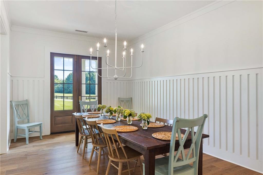 9311 Waterworks Road Chattahoochee Hills, GA 30268 - Photo 13 of 57 a view of a dining room with furniture window and wooden floor