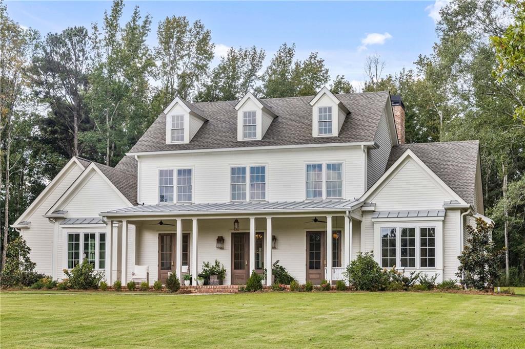 9311 Waterworks Road Chattahoochee Hills, GA 30268 - Photo 2 of 57 a front view of a house with a garden