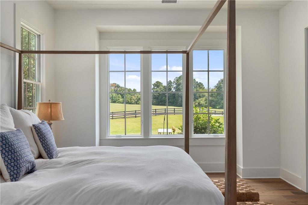 9311 Waterworks Road Chattahoochee Hills, GA 30268 - Photo 21 of 57 a bedroom with a large bed and a large window