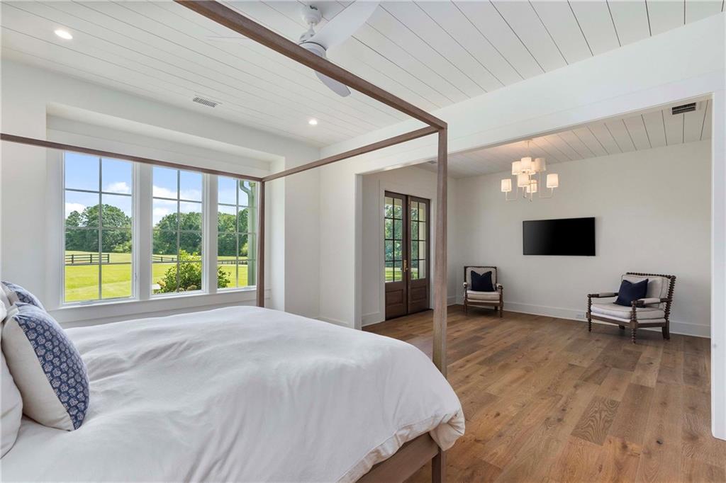 9311 Waterworks Road Chattahoochee Hills, GA 30268 - Photo 22 of 57 a bedroom with a bed and large windows