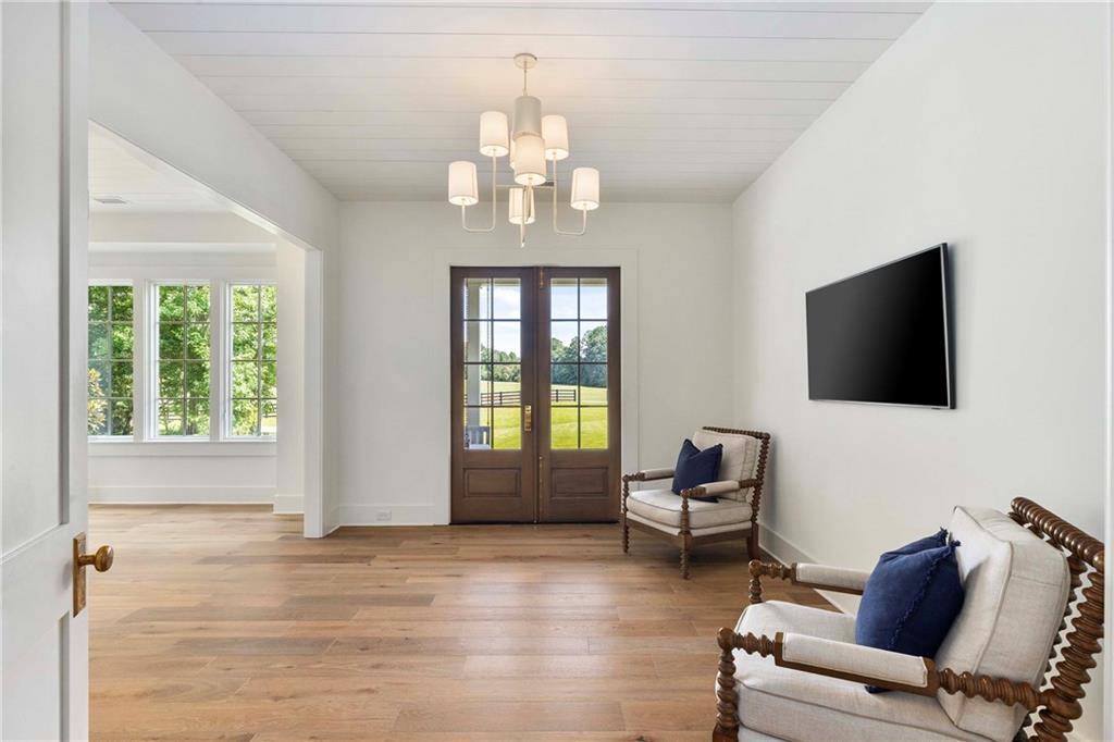 9311 Waterworks Road Chattahoochee Hills, GA 30268 - Photo 23 of 57 a living room with furniture and a flat screen tv