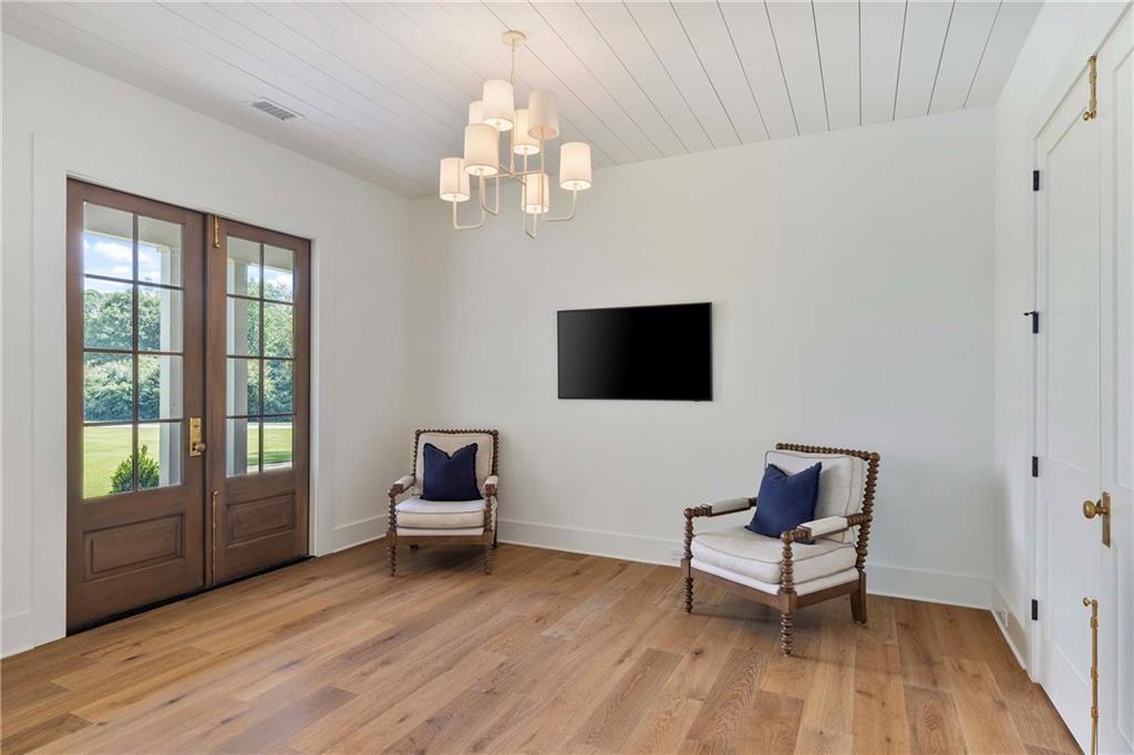 9311 Waterworks Road Chattahoochee Hills, GA 30268 - Photo 25 of 57 a living room with furniture and a flat screen tv