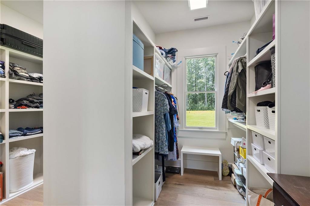 9311 Waterworks Road Chattahoochee Hills, GA 30268 - Photo 31 of 57 a view of walk in closet with clothes and shoes