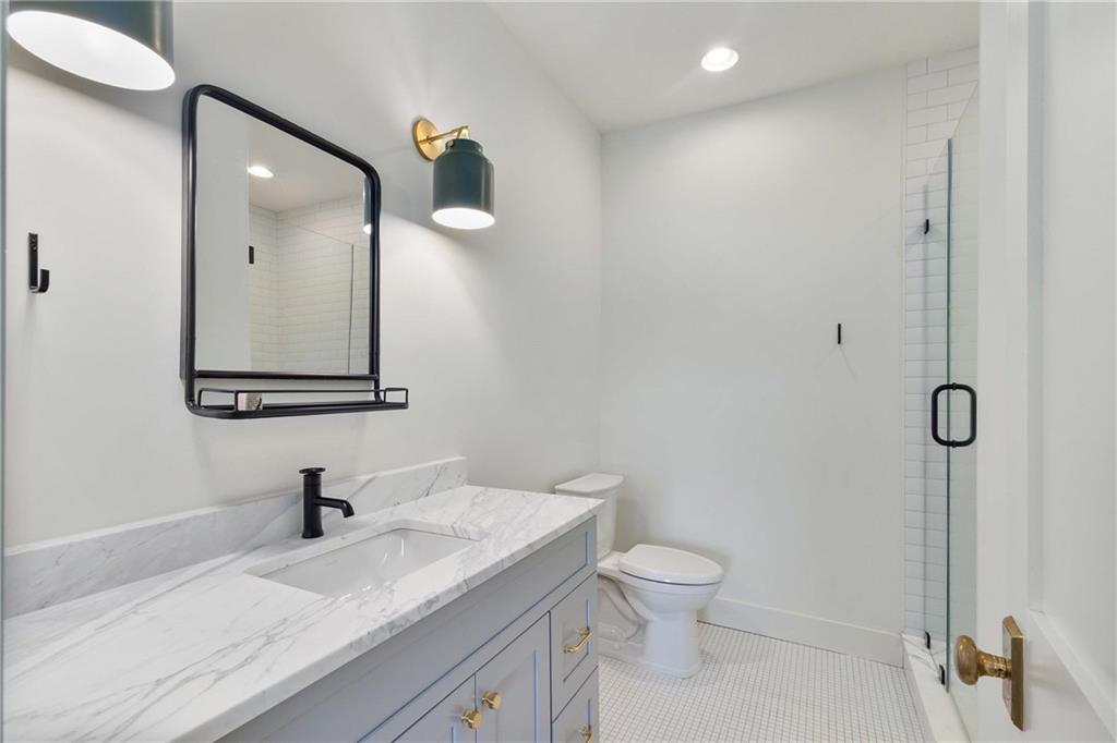 9311 Waterworks Road Chattahoochee Hills, GA 30268 - Photo 48 of 57 a bathroom with a granite countertop sink mirror and toilet