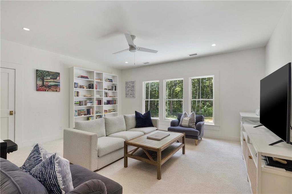 9311 Waterworks Road Chattahoochee Hills, GA 30268 - Photo 49 of 57 a living room with furniture and a flat screen tv