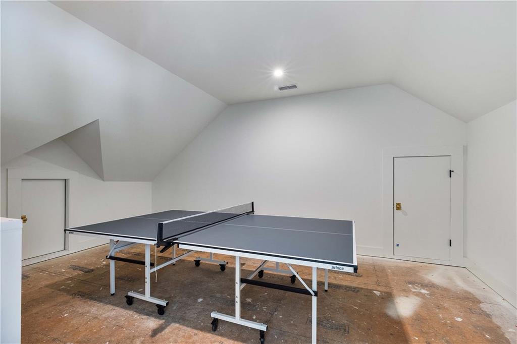 9311 Waterworks Road Chattahoochee Hills, GA 30268 - Photo 50 of 57 a living room with a table and white walls