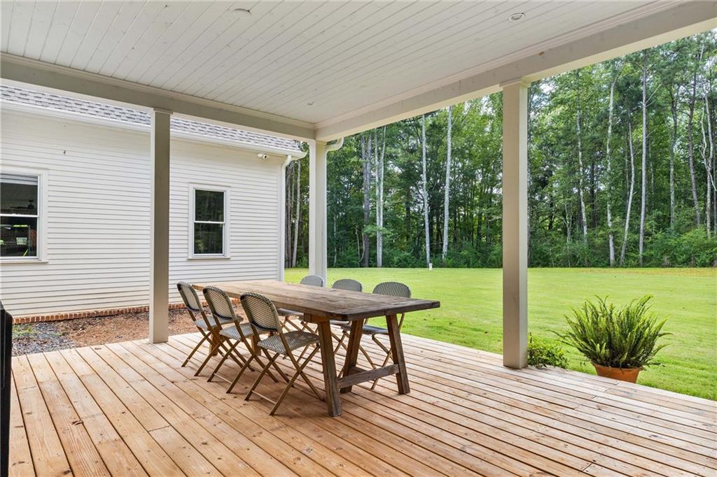 9311 Waterworks Road Chattahoochee Hills, GA 30268 - Photo 51 of 57 a view of a patio with a table chairs and backyard