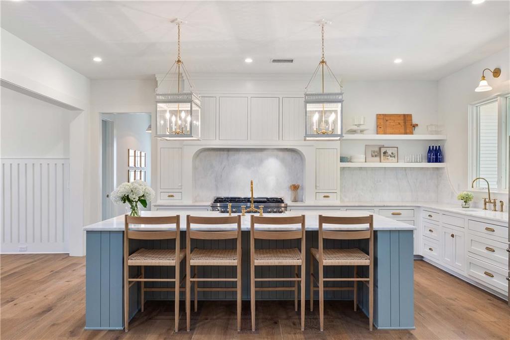 9311 Waterworks Road Chattahoochee Hills, GA 30268 - Photo 7 of 57 a kitchen with a dining table chairs wooden floor and cabinets