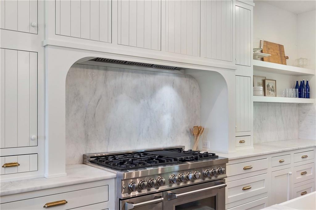 9311 Waterworks Road Chattahoochee Hills, GA 30268 - Photo 9 of 57 a kitchen with white cabinets and a stove