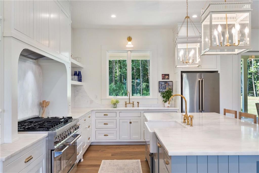 9311 Waterworks Road Chattahoochee Hills, GA 30268 - Photo 10 of 57 a kitchen with a stove a sink and a refrigerator