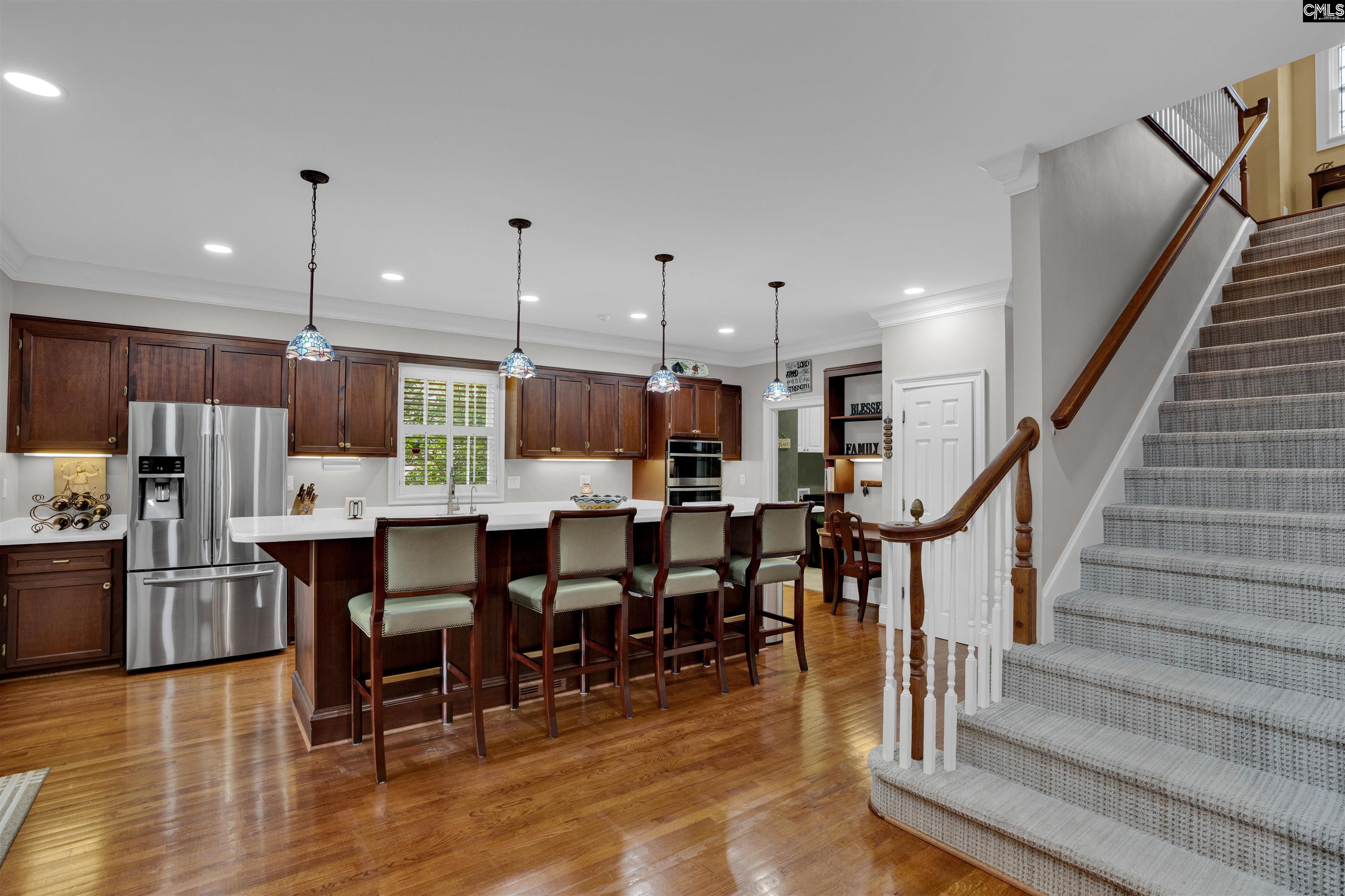 1101 Ellett Road Chapin, SC 29036 - Photo 6 of 24 a open kitchen with stainless steel appliances kitchen island granite countertop a table chairs sink and cabinets