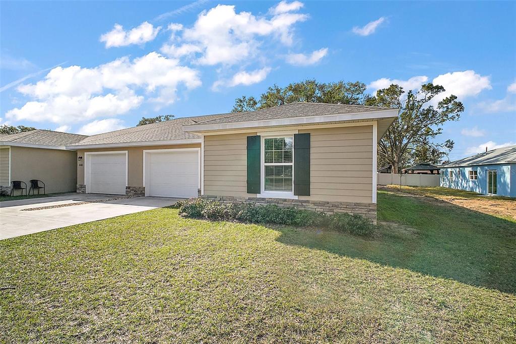 444 Fahnstock Street Eustis, FL 32726 - Photo 18 of 25 a backyard of a house with table and chairs