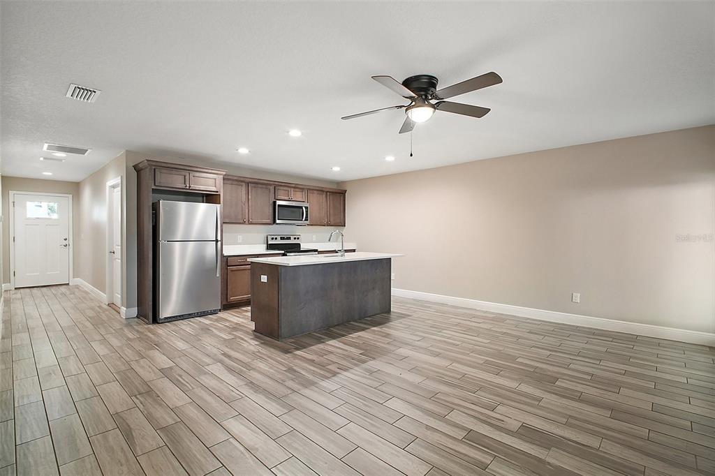 444 Fahnstock Street Eustis, FL 32726 - Photo 2 of 25 a view of kitchen with stainless steel appliances granite countertop a stove and a refrigerator