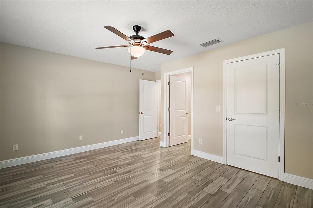444 Fahnstock Street Eustis, FL 32726 - Photo 9 of 25 a view of empty room with wooden floor and fan