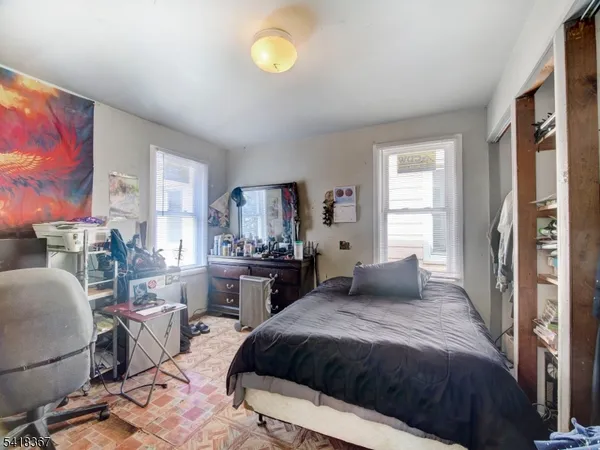 a bedroom with a bed a couch and dresser