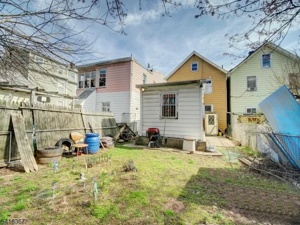 a view of a backyard with table and chairs